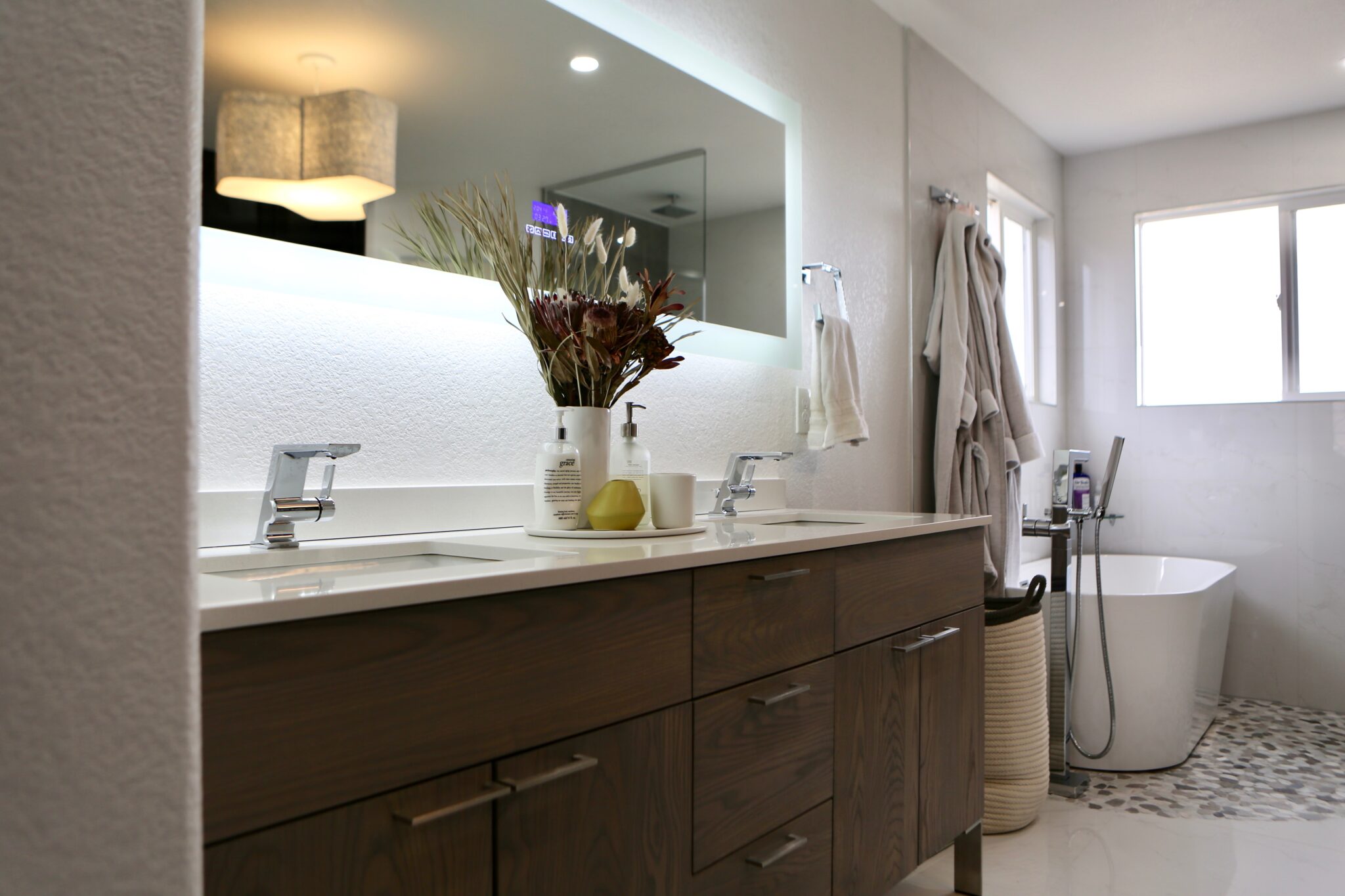 Full bathroom with double vanity and patterned tile floor